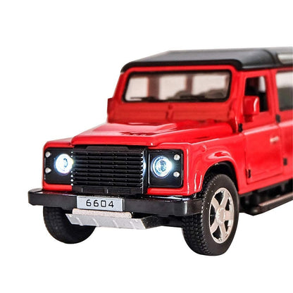 Red toy Land Rover Defender on a white background