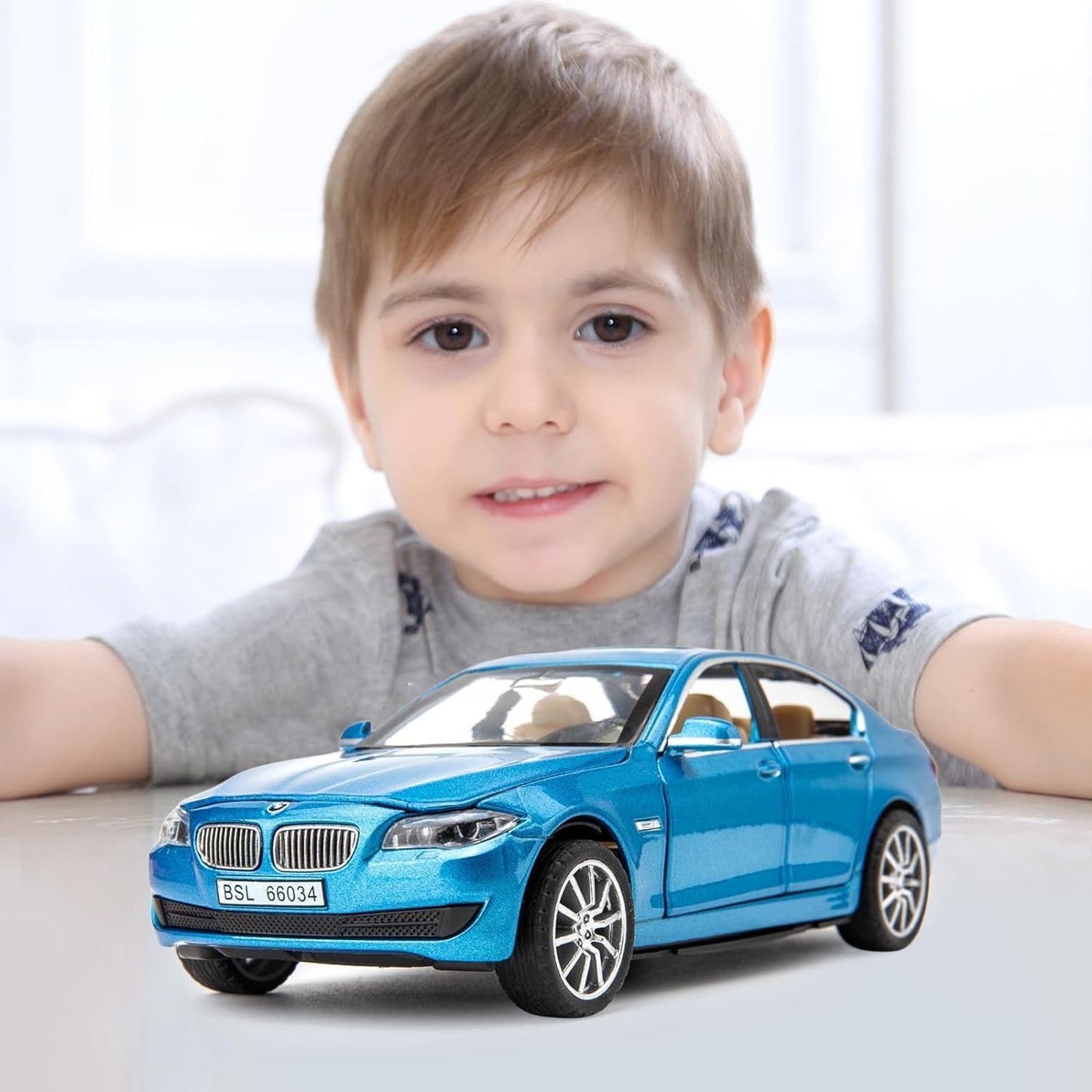 Child with a blue toy car on a light background