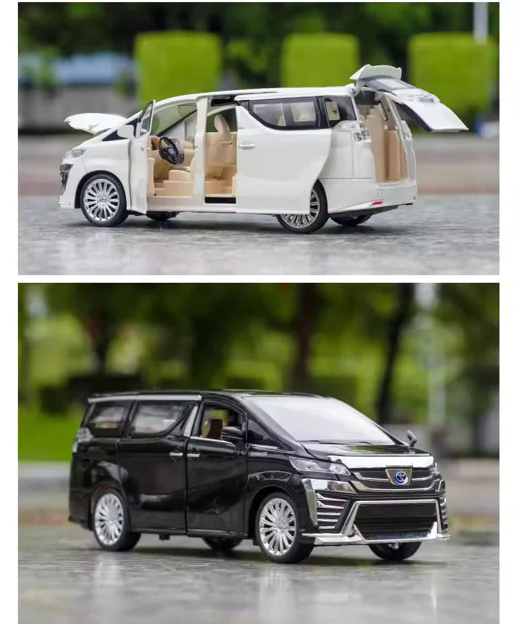 Two toy models of vans, one white and one black, on a road with blurred greenery in the background.